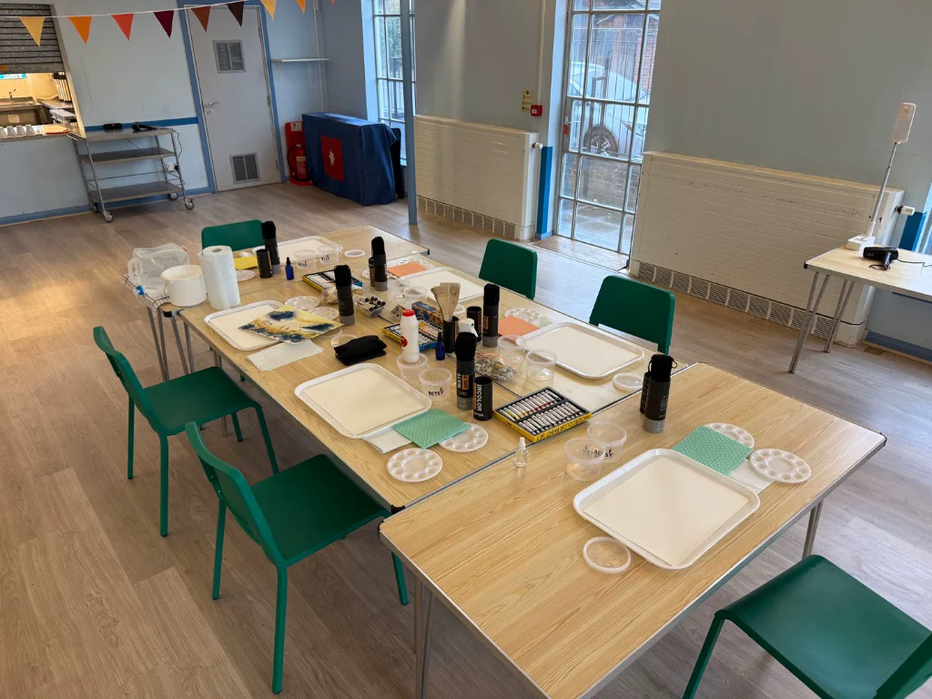 Watercolour workshop materials setup with paints brushes and paper ready for beginners